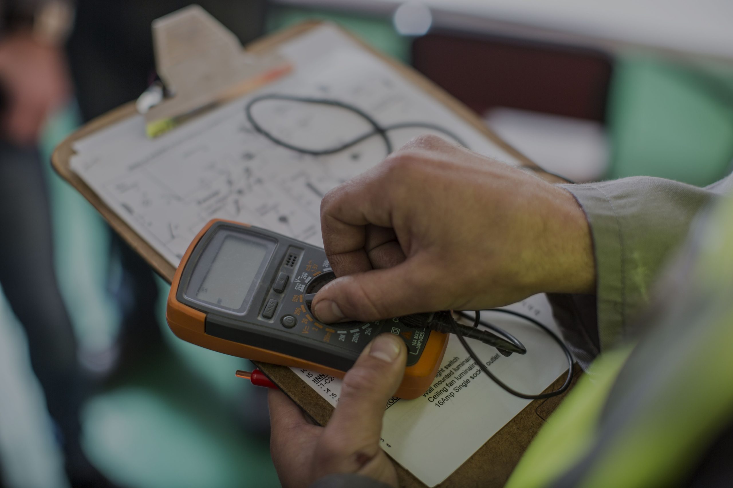 Electrician holding mobile device